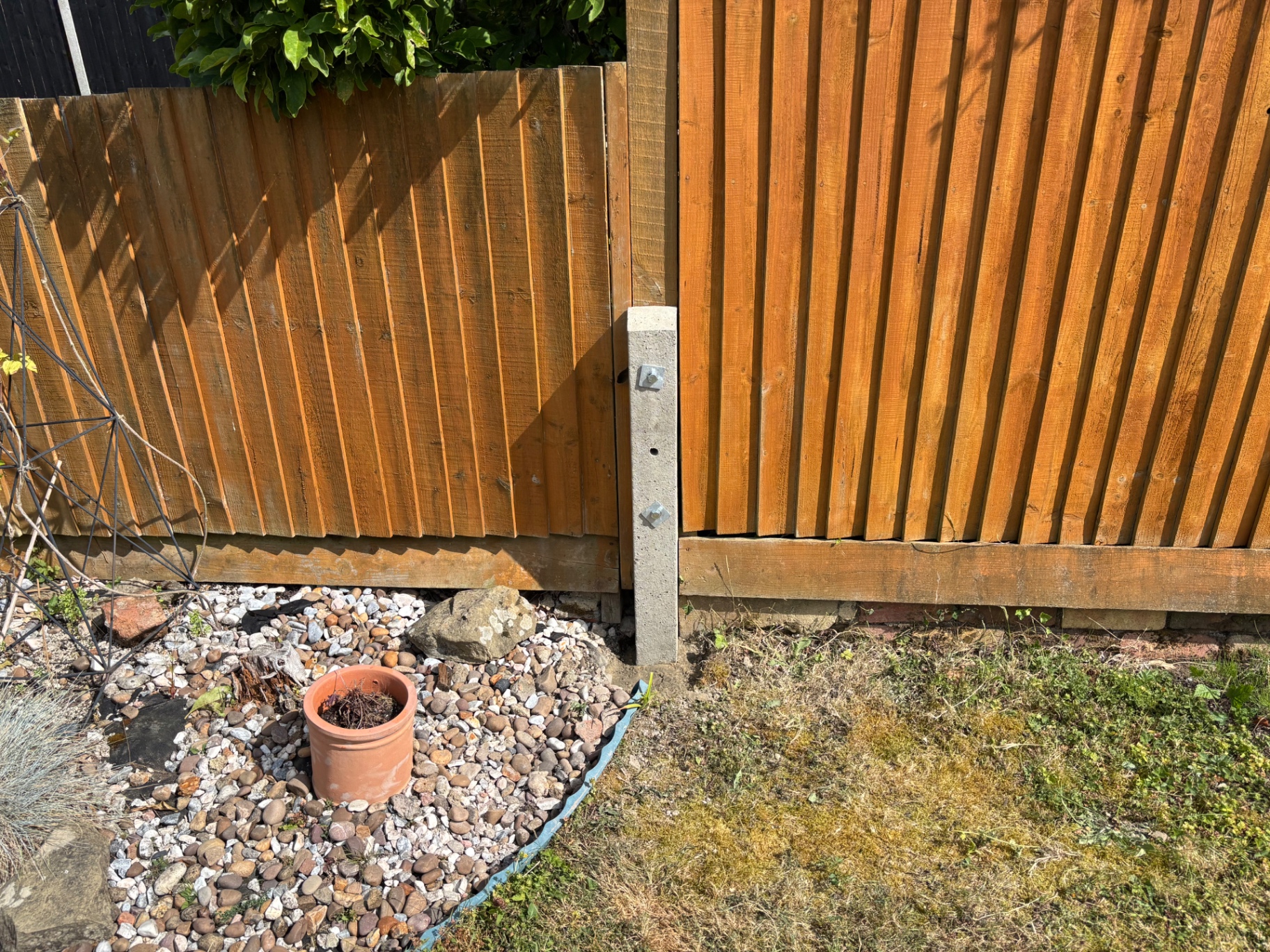 Concrete spur bolted to the existing timber post to straighten and reinforce the fence line