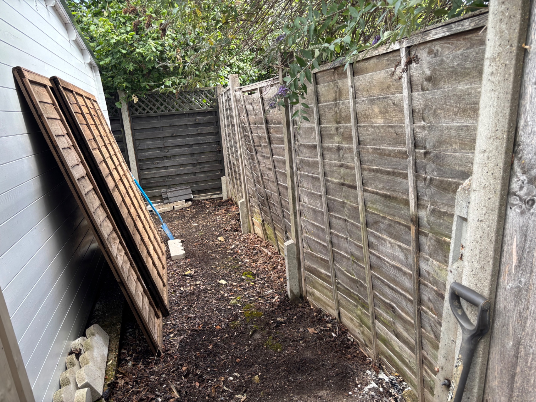 Failed fence panels and posts removed — before