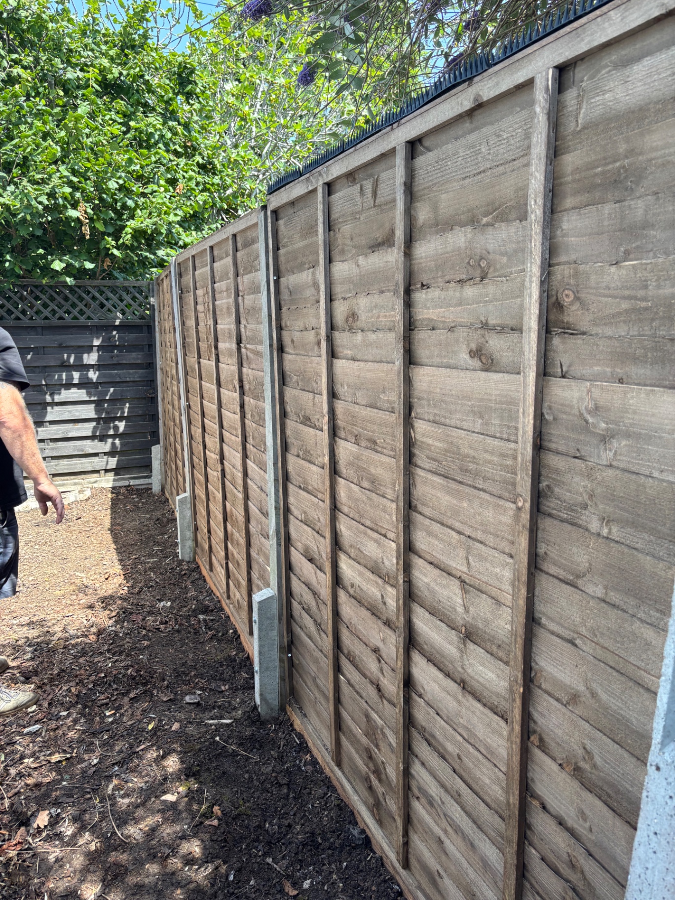 New posts and panels installed with anti-climb trim — after