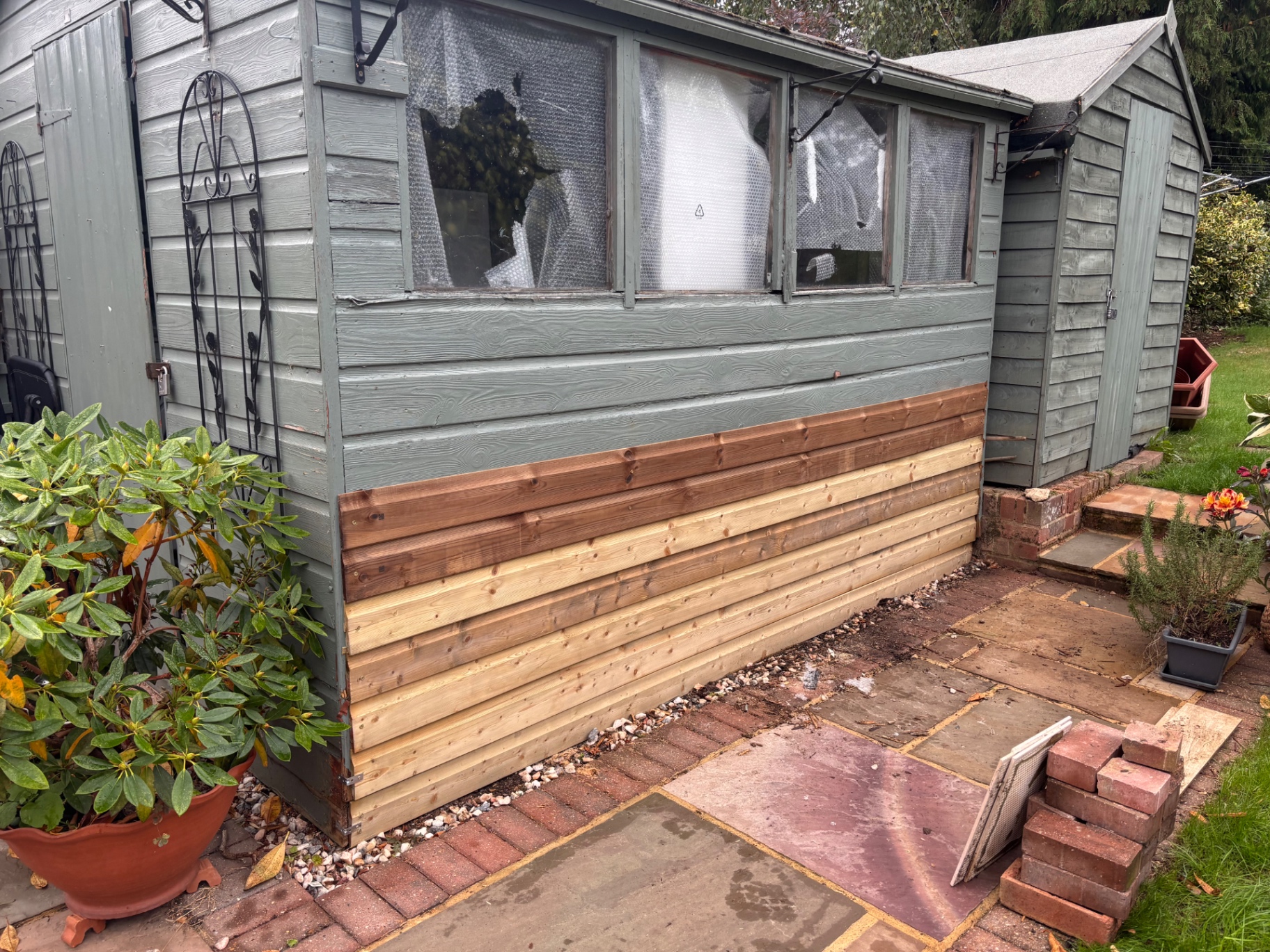 Fully re-clad lower elevation with new treated timber boards — after