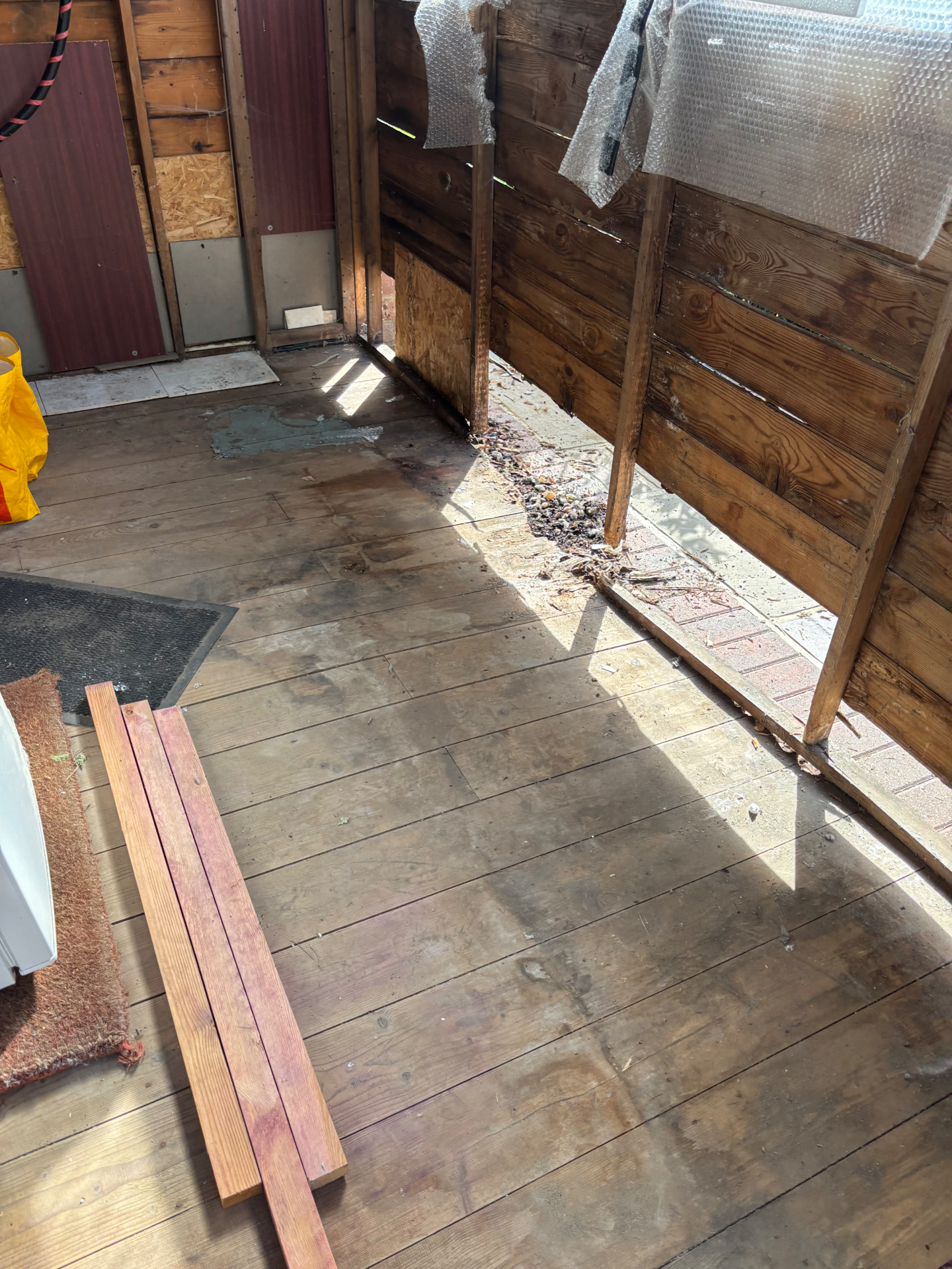 Damaged boarding stripped out inside, ready for the repair — before